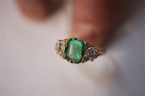 A Victorian style 18ct gold, three stone emerald and diamond ring, size T.